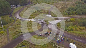 View of SUVs riding on puddle. Clip. Top view of surmounting puddles of SUVs on mud races. Jeep racing photo