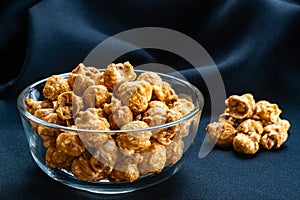 View of sweet caramel almonds in transparent glass bowl