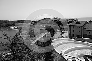 View on swimming pool, lake and sea at Thracian Cliffs resort in black and white