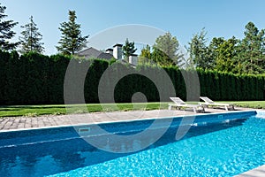 view of swimming pool with sunbeds