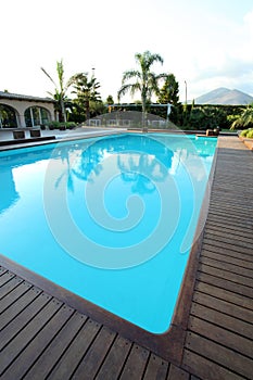 View of swimming pool with teck wood flooring