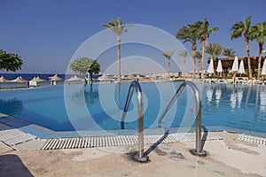 View of a swimming pool in tropical warm place in summer. Copy s