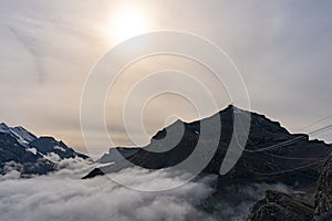 View of Swiss Alps over clouds on a bright sunny day