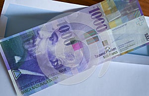 View of the Swiss francs currency on the mailer