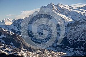 View of the Swiss mountains in winter. Mittelhornin clouds, Schreckhorn and Wetterhorn. Swiss alps in Switzerland Jungfrauregion