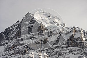 View of the Swiss mountains in winter. Mittelhornin clouds, Schreckhorn and Wetterhorn. Swiss alps in Switzerland Jungfrauregion