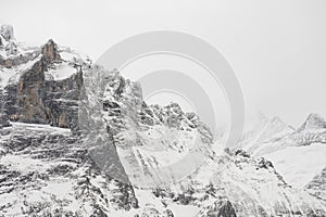 View of the Swiss mountains in winter. Mittelhornin clouds, Schreckhorn and Wetterhorn. Swiss alps in Switzerland Jungfrauregion