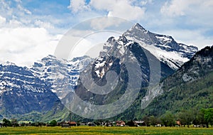 View of the Swiss village at the foot of the mountains