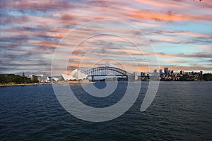 View of Sydney Harbour NSW Australia. Ferry boats partly cloudy colourful skies blue waters