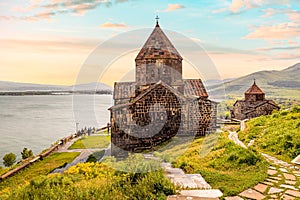 View of symbol of tourist Armenia - Sevanavank Monastery on the peninsula overlooking Lake Sevan in sunny weather