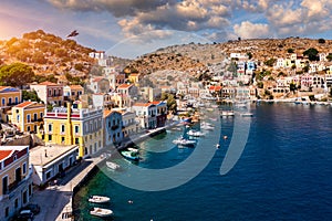 View on Symi (Simi) island harbor port, classical ship yachts, houses on island hills, Aegean Sea bay. .