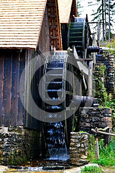 View of a system of water wheels driving a hammer and a mill for processing mined gold ore