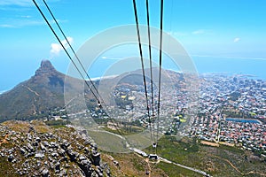 View from Table Mountain National Park to Lions Head Peak, Cape Town and Robben Island. Under the massive wires of the cable car.