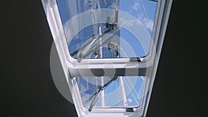 View of tackle and mast of yacht through window of yacht cabin