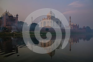 View of Taj Mahal with early morning fog reflected in Yamuna River, Agra, Uttar Pradesh, India