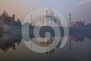 View of Taj Mahal with early morning fog reflected in Yamuna River, Agra, Uttar Pradesh, India