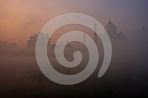 View of Taj Mahal reflected in Yamuna river with early morning fog, Agra, Uttar Pradesh, India