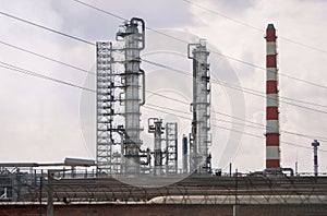 View of tall  oil refinery pipes in summer on a clear day