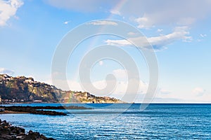 View of Taormina cape and rainbow in Ionian Sea