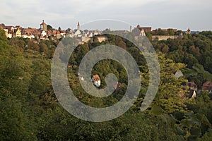 View of the Tauber valley and skyline of walled city in late afternoon light photo