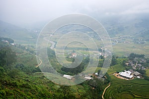 View of Tavan village on rice field terraced with river in foggy