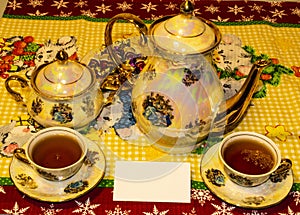 view of Tea for two prepared in an old ceramic water kettle