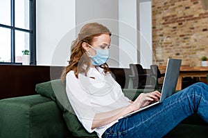 View of teleworker in medical mask photo