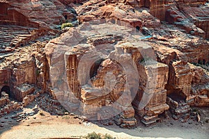 View of temples carved into sandstone rocks at daytime in Siq Gorge, Petra, Jordan.