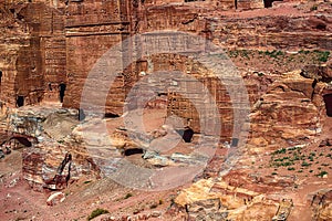 View of the Temples and caves carved into the sandstone rock in the gorge. Petra, Jordan