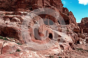 View of the Temples and caves carved into the sandstone rock in the gorge. Petra, Jordan