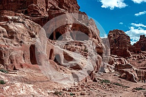 View of the Temples and caves carved into the sandstone rock in the gorge. Petra, Jordan