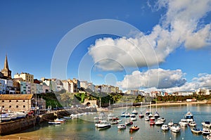 View of Tenby harbour against a blue summer sky.