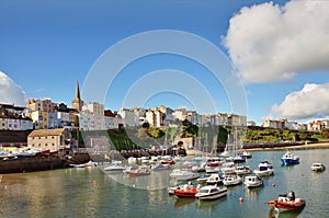 View of Tenby harbour and town on a summers day .