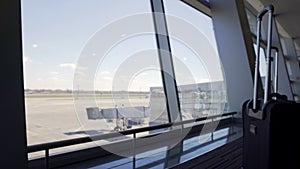 View through terminal window, gate and empty runway at airport, transportation