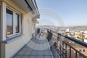 View from a terrace of a top floor apartment. You can see the town below and the mountains in the distance