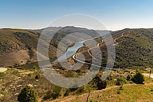 View of the terraced vineyards in the Douro Valley and river near the village of Pinhao, Portugal. Concept for travel in Portugal