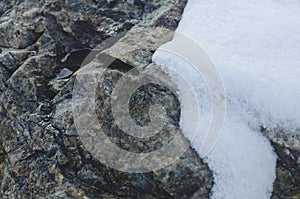 A little bit of snow on the granite stone.