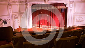 View from within a theater with stage chairs and curtain