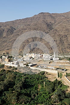 View from the Thee-Ain heritage site in Al-Baha, Saudi Arabia towards the village of the same name photo