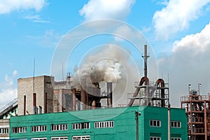 View of a thermal power plant or a factory for the production and processing of petroleum products. Large industrial chimneys