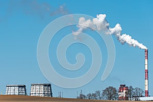 View of a thermal power plant or a factory for the production and processing of petroleum products. Large industrial chimneys