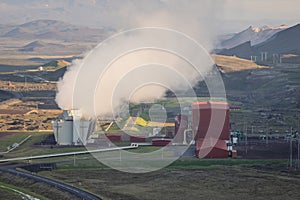 View of thermoelectric geothermal power and heating plant close to Krafla, Iceland with visible pipes, scenery, lake, tower,