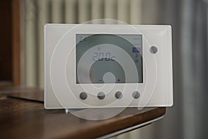 view of a thermostat set with a temperature of twenty degrees