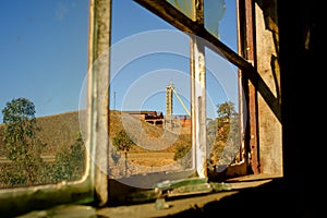 View thought a broken window to an old Factory