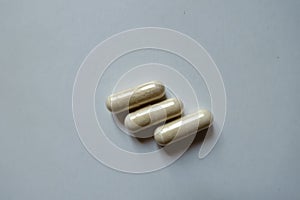 View of three beige capsules of Saccharomyces boulardii probiotic from above