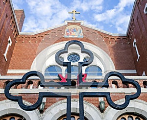 View throught a cross on the red brick building of an old Russian Orthodox church 