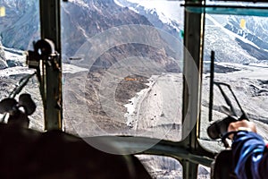 View throw Helicopter Cockpit Approaching to High Altitude Base