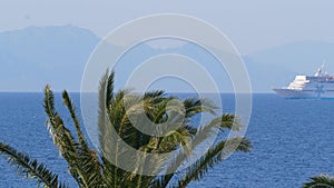 View thru palm trees Ship sailing close to Turkey coast view from the Greece