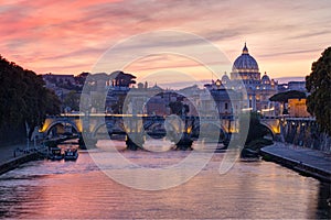 View from the Tiber on Ponte Sant`Angelo and St. Peter`s Basilica in the twilight,  Rome, Italy