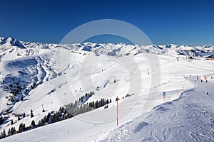 View to Alpine mountains and ski slopes in Austria from Kitzbuehel ski resort.